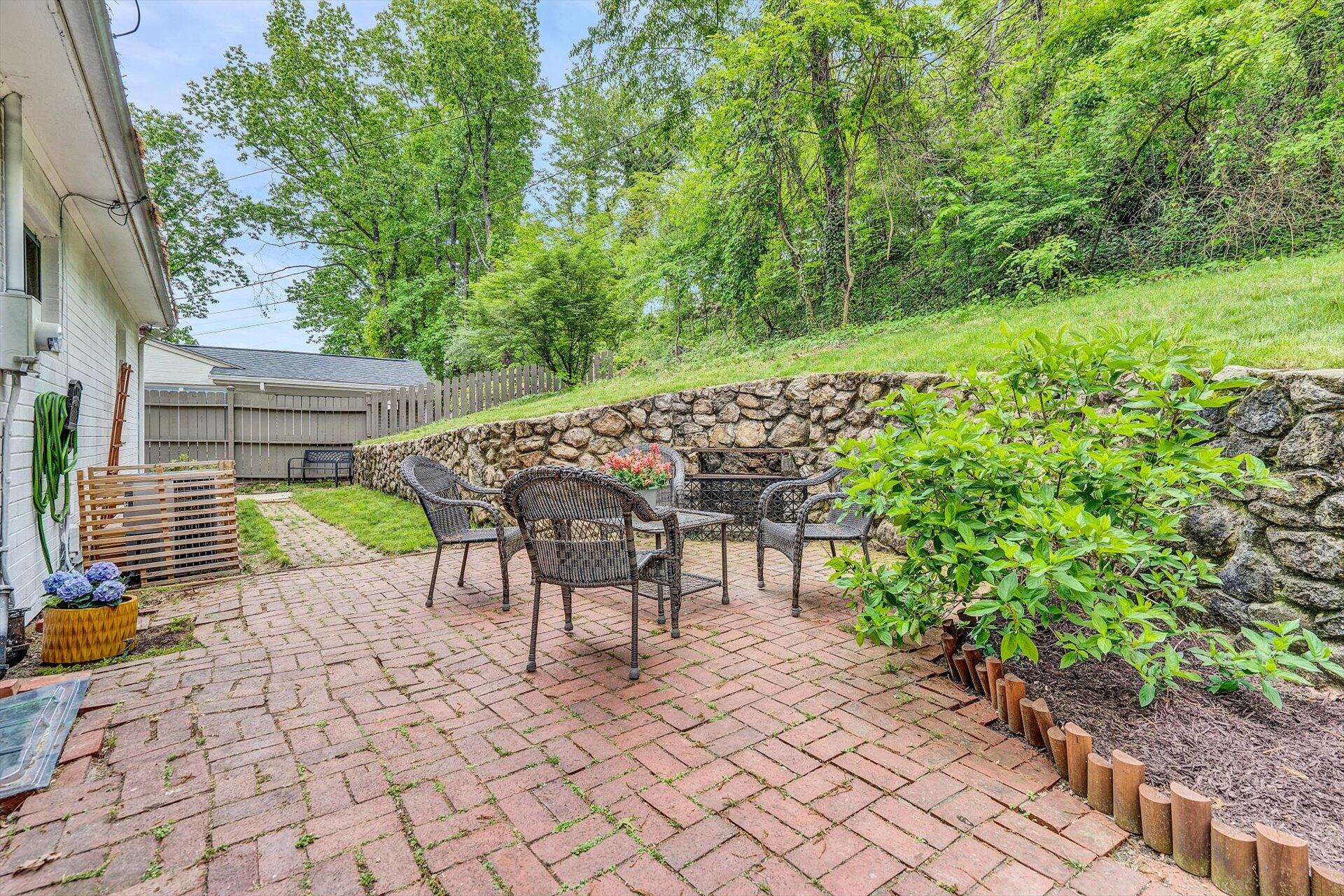 3038 Burnleigh Road Southwest Roanoke, VA 24014 - Photo 28 of 34 a chair and table sitting in backyard of house