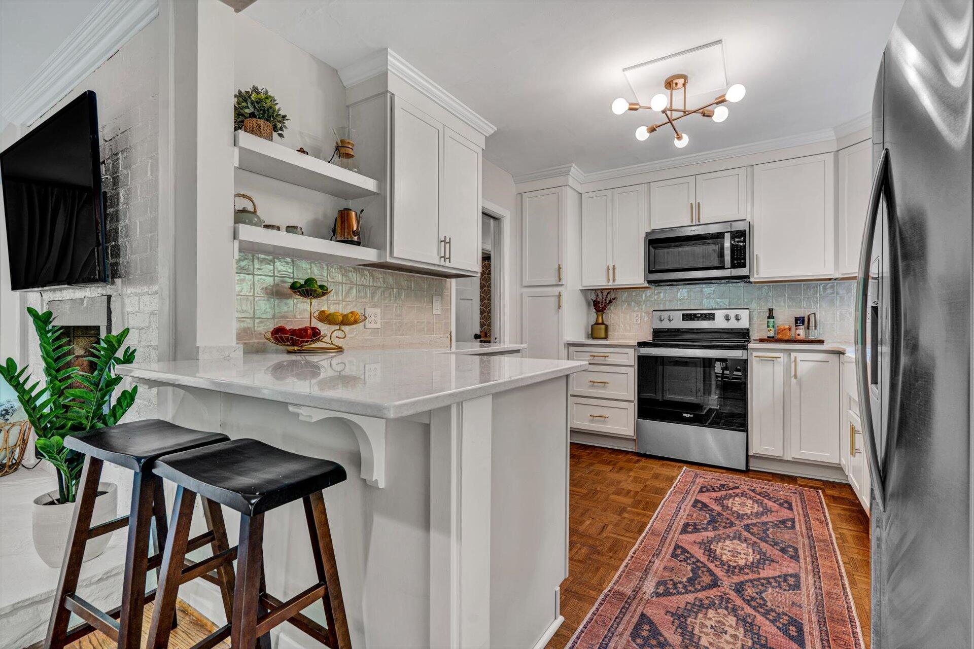 3038 Burnleigh Road Southwest Roanoke, VA 24014 - Photo 8 of 34 a kitchen with stainless steel appliances granite countertop a refrigerator a stove a sink dishwasher and white cabinets with wooden floor