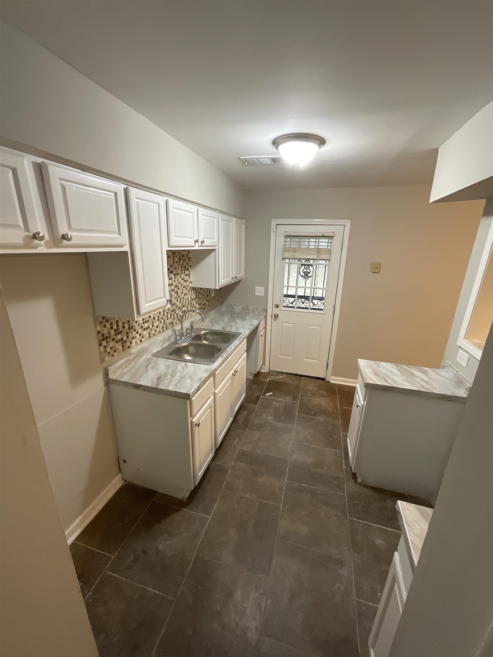 1175 Fiber Road Memphis, TN 38109 - Photo 3 of 9 a kitchen with a stove a refrigerator and cabinets