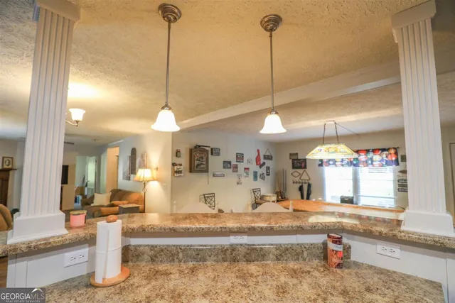 a dining table chairs and a chandelier