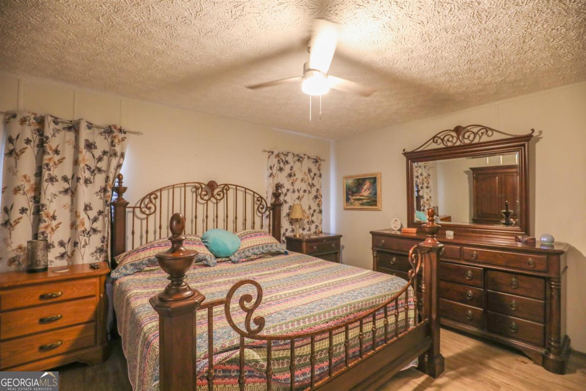 118 Napier Mill Road Southwest Eatonton, GA 31024 - Photo 15 of 33 a bedroom with a bed and a dresser