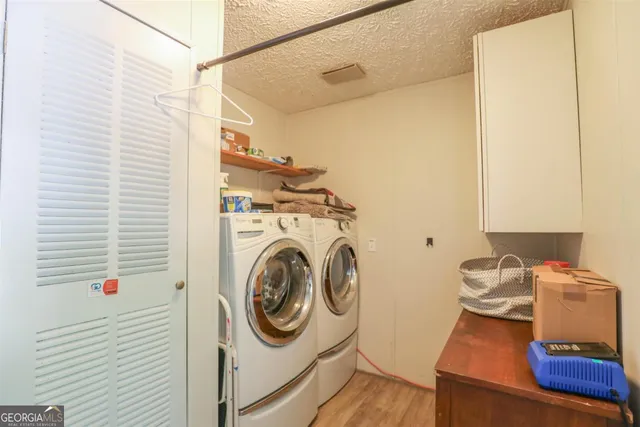 a view of a hallway with washer and dryer