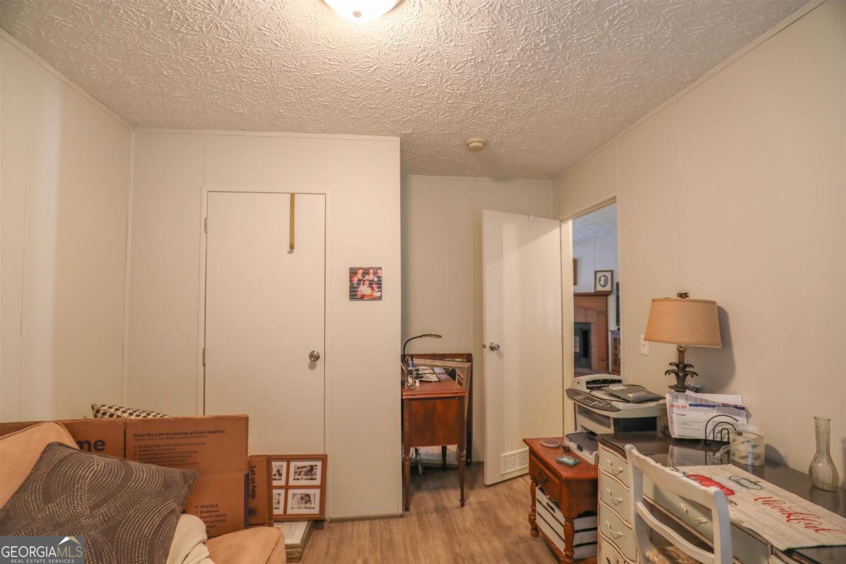 118 Napier Mill Road Southwest Eatonton, GA 31024 - Photo 25 of 33 a room with furniture and wooden floor