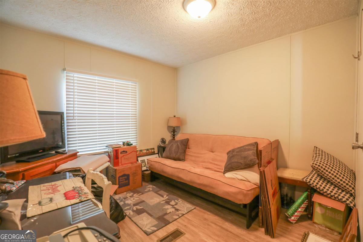 118 Napier Mill Road Southwest Eatonton, GA 31024 - Photo 26 of 33 a living room with furniture and a window