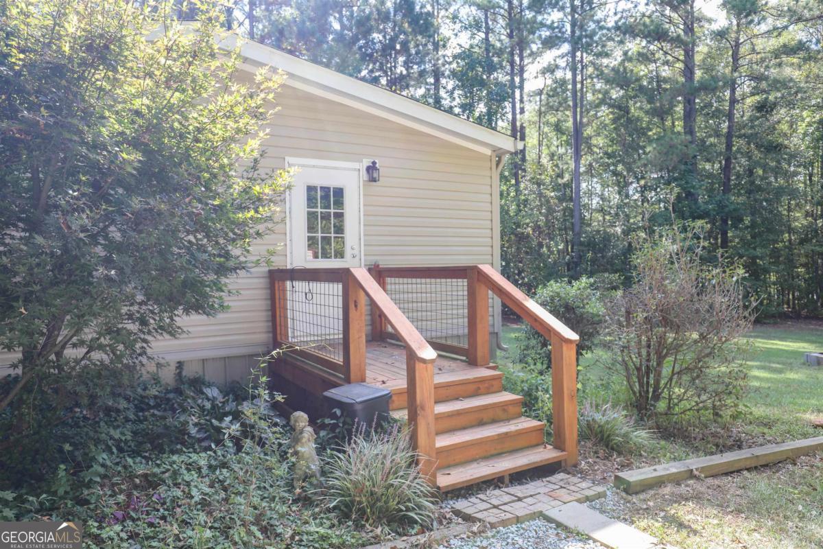 118 Napier Mill Road Southwest Eatonton, GA 31024 - Photo 28 of 33 a view of a house with backyard and trees