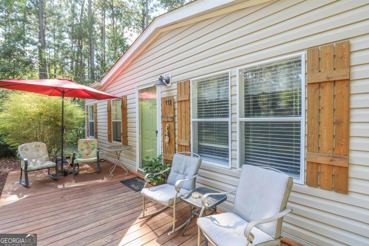 118 Napier Mill Road Southwest Eatonton, GA 31024 - Photo 3 of 33 a balcony with furniture and wooden floor