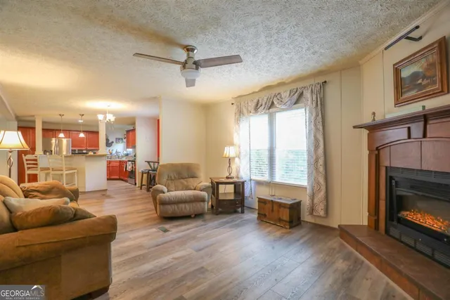 a living room with furniture large window and a fireplace
