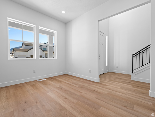 18 South Crimson Way, Unit 304 Mapleton, UT 84664 - Photo 5 of 17 Spare room featuring light wood-type flooring, stairs, and recessed lighting