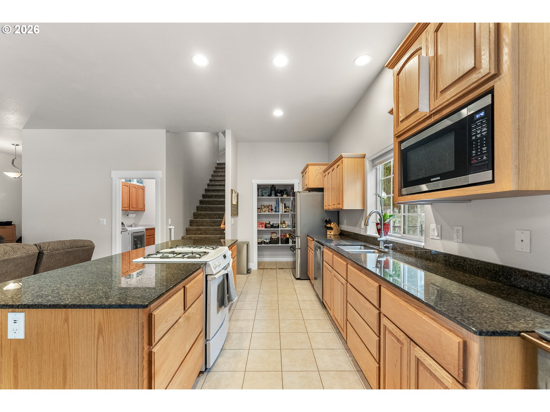 554 Oak Valley Loop Winchester, OR 97495 - Photo 12 of 42 a kitchen with stainless steel appliances granite countertop a sink a stove and oven