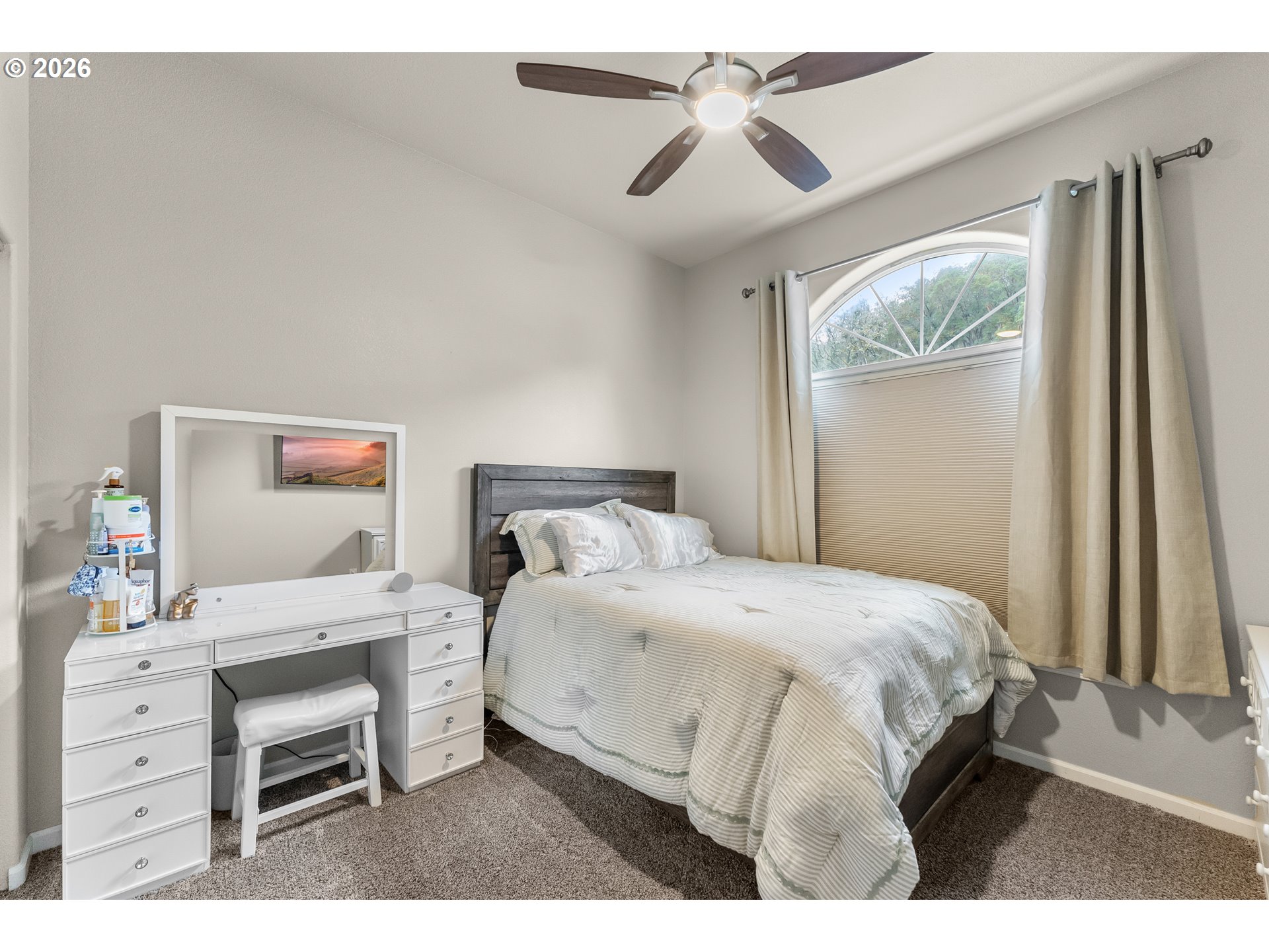 554 Oak Valley Loop Winchester, OR 97495 - Photo 23 of 42 a bedroom with a bed a chandelier and a dresser