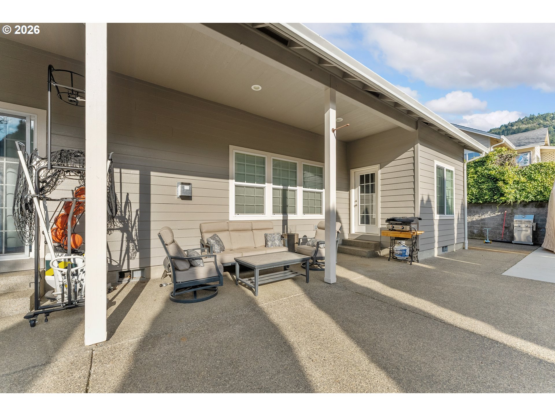 554 Oak Valley Loop Winchester, OR 97495 - Photo 39 of 42 a living room with furniture a large window and potted plants