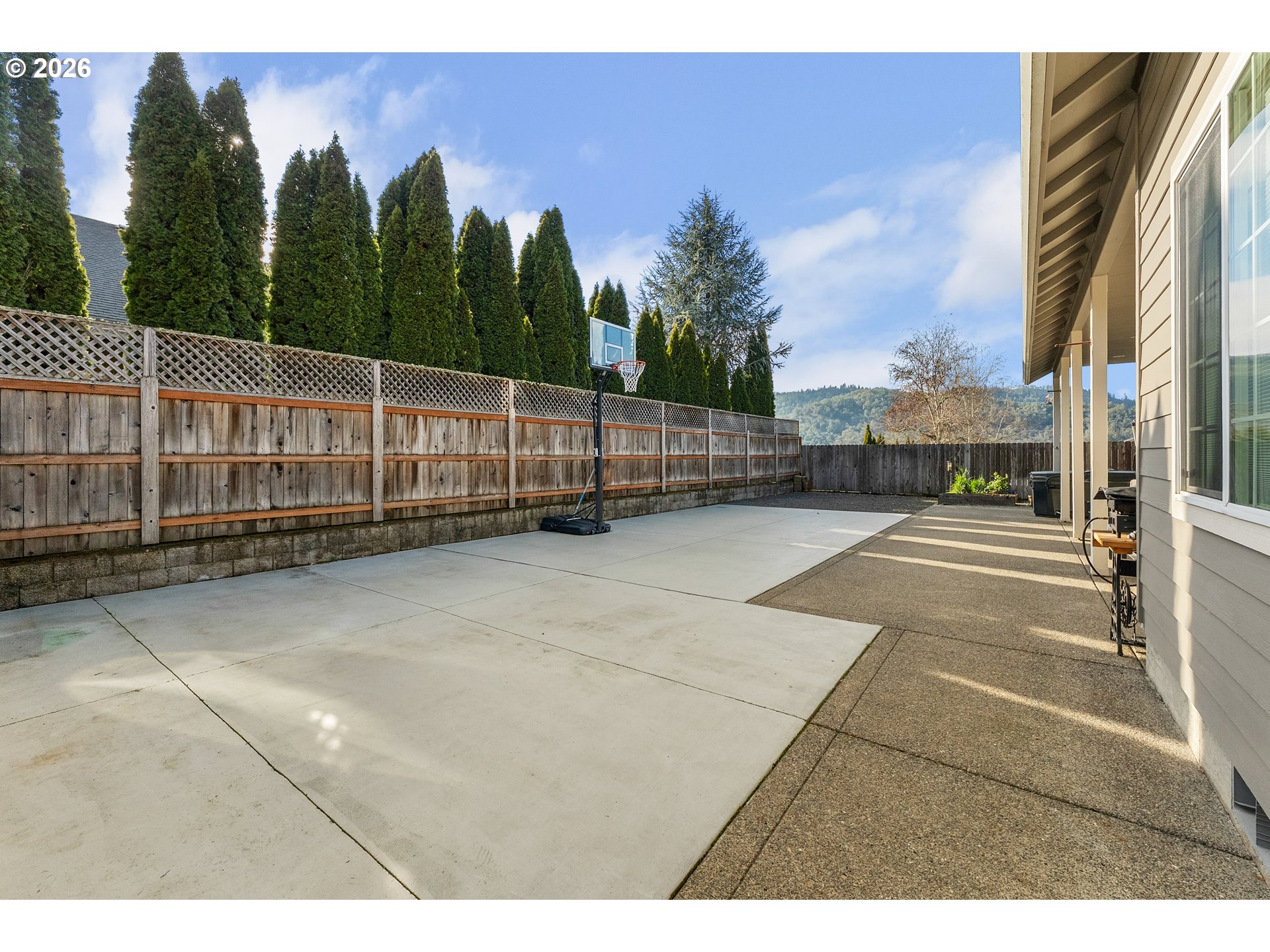 554 Oak Valley Loop Winchester, OR 97495 - Photo 41 of 42 a view of a balcony with floor to ceiling windows and wooden fence