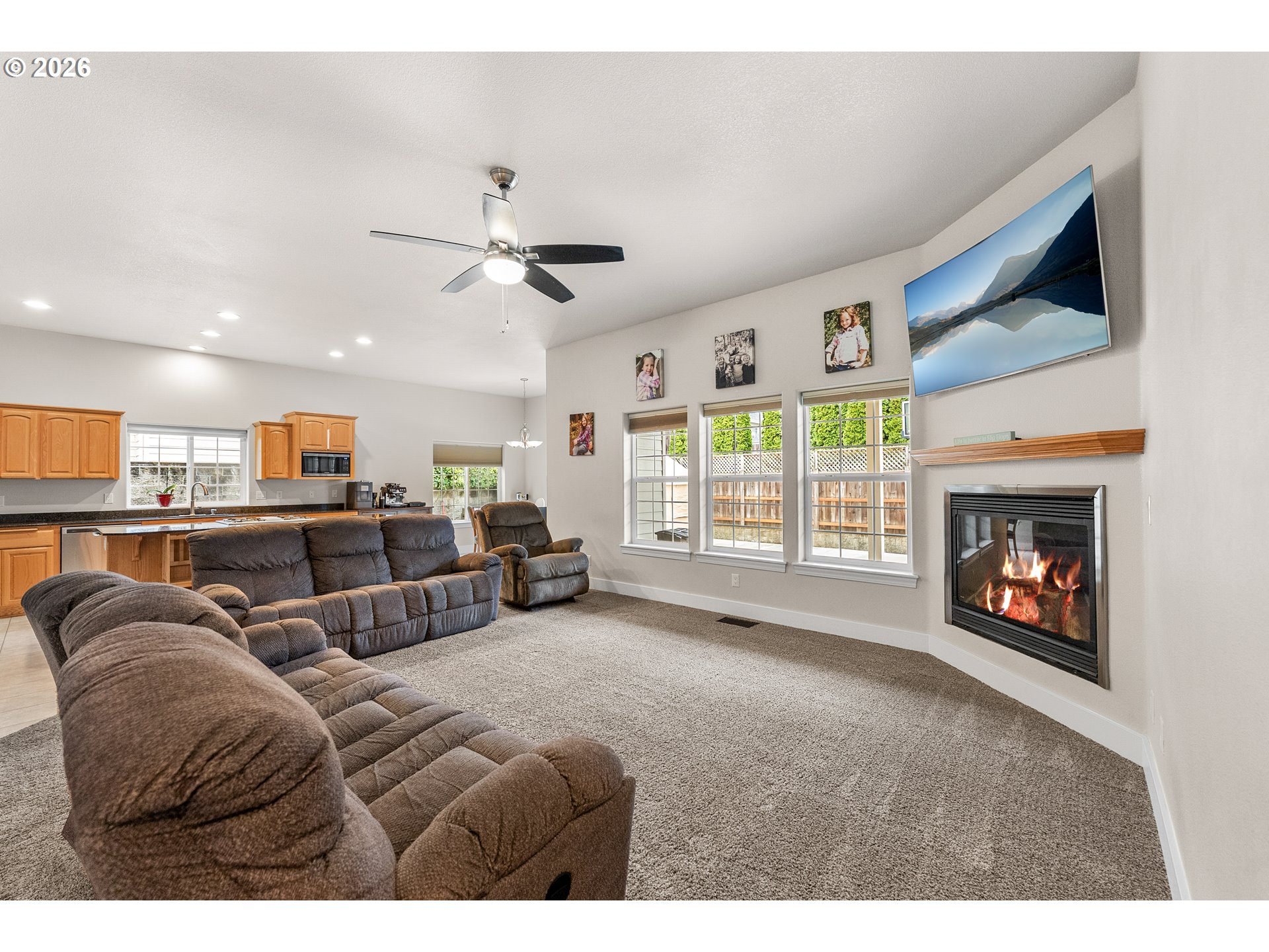 554 Oak Valley Loop Winchester, OR 97495 - Photo 5 of 42 a living room with furniture a flat screen tv and a fireplace