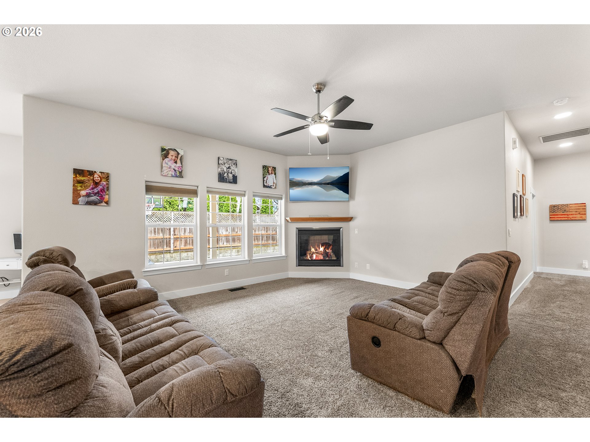 554 Oak Valley Loop Winchester, OR 97495 - Photo 6 of 42 a living room with furniture a fireplace and a large window