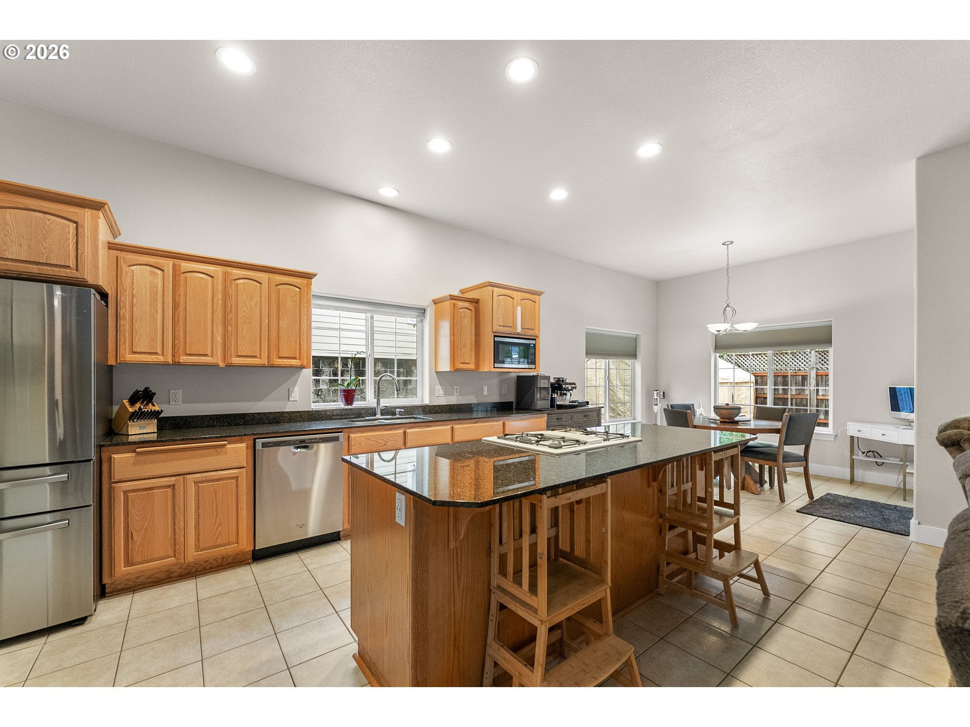 554 Oak Valley Loop Winchester, OR 97495 - Photo 9 of 42 a kitchen with stainless steel appliances granite countertop a sink a stove a refrigerator cabinets and living room view