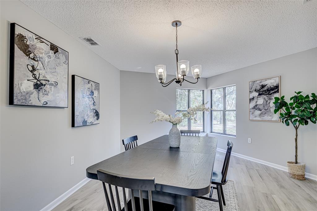 900 Highway 630 East Frostproof, FL 33843 - Photo 12 of 56 a view of a dining room with furniture window and wooden floor