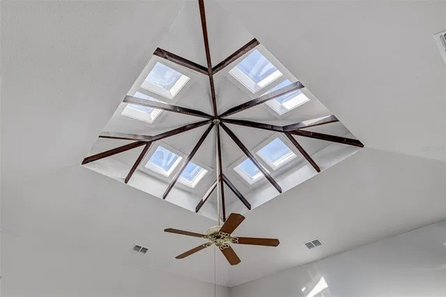 a kitchen with a refrigerator sink and white cabinets with wooden floor