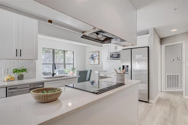 a kitchen with a dining table and chairs