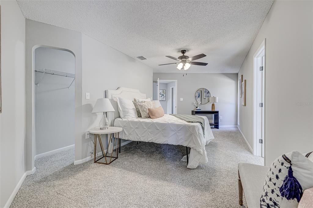900 Highway 630 East Frostproof, FL 33843 - Photo 19 of 56 a spacious bedroom with a bed and a chandelier