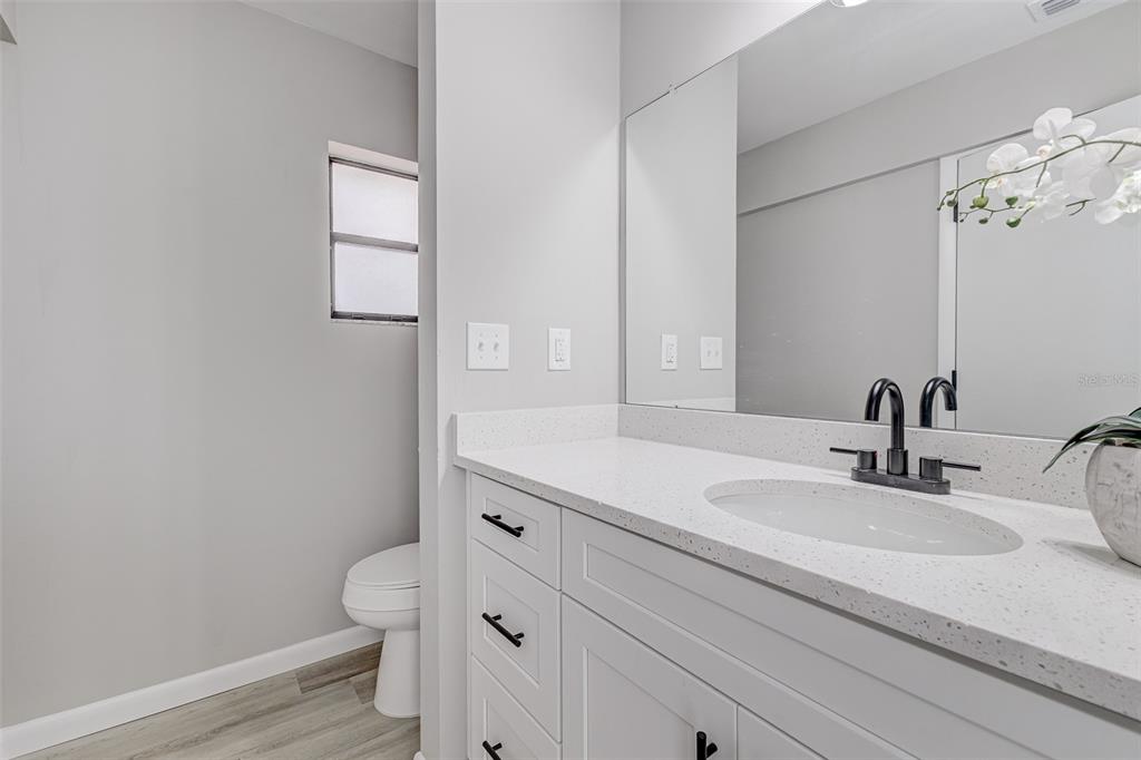 900 Highway 630 East Frostproof, FL 33843 - Photo 22 of 56 a bathroom with a sink a toilet and shower