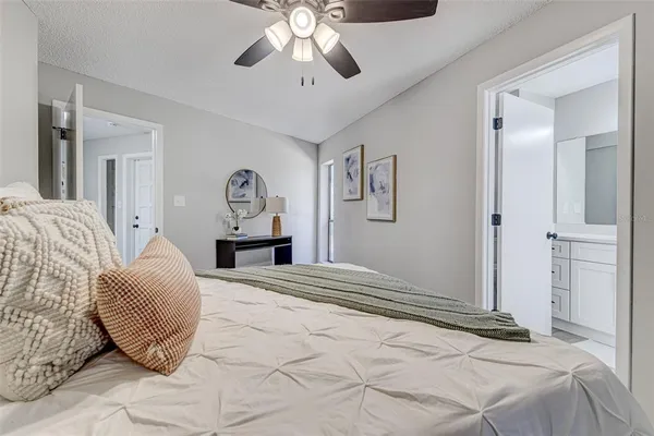 a bedroom with a bed and a chandelier