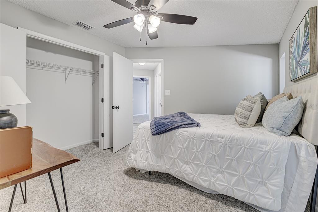 900 Highway 630 East Frostproof, FL 33843 - Photo 26 of 56 a bedroom with a bed and a chandelier