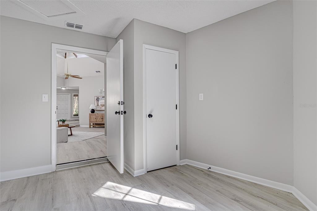 900 Highway 630 East Frostproof, FL 33843 - Photo 38 of 56 a view of a hallway with wooden floor and a bathroom