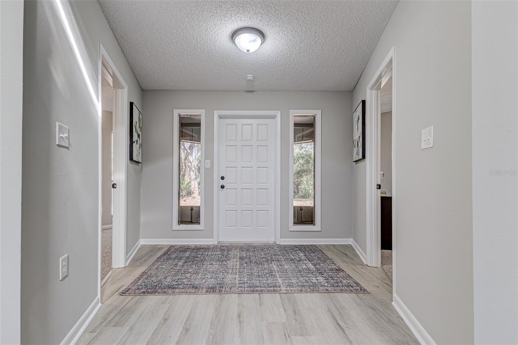 900 Highway 630 East Frostproof, FL 33843 - Photo 4 of 56 wooden floor in a hall with an entryway