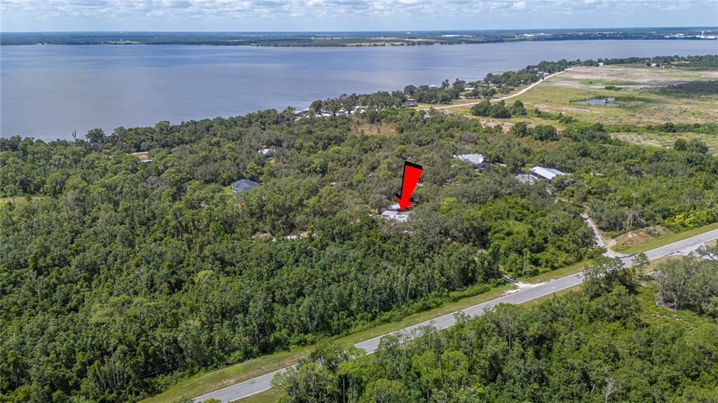 900 Highway 630 East Frostproof, FL 33843 - Photo 49 of 56 a view of a houses with a yard and lake