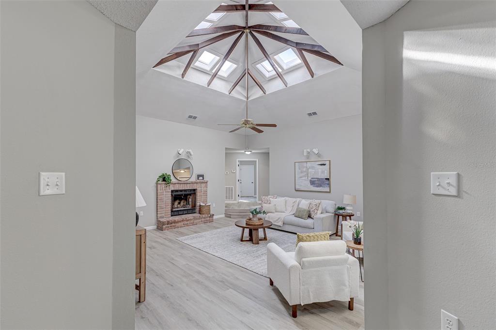 900 Highway 630 East Frostproof, FL 33843 - Photo 5 of 56 a living room with furniture a fireplace and a chandelier