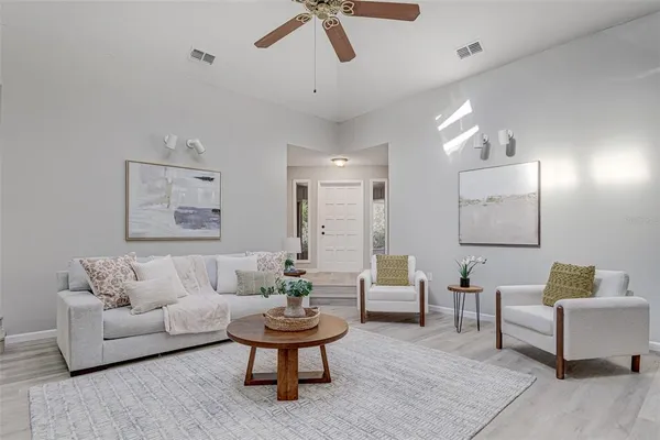 a living room with furniture and a potted plant