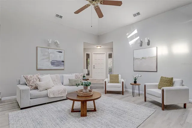 a living room with furniture and a potted plant