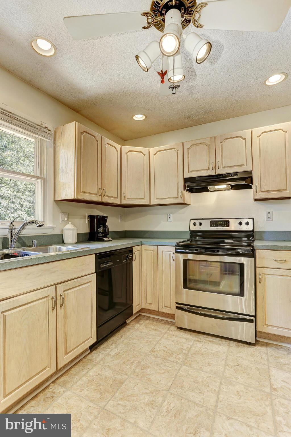 4149 Salem Bottom Road Westminster, MD 21157 - Photo 5 of 25 a kitchen with kitchen island granite countertop a stove a sink and a microwave