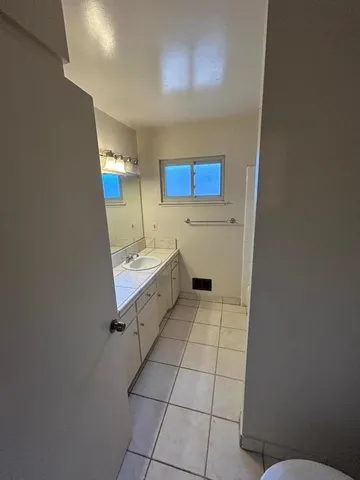 a bathroom with a sink a toilet and mirror