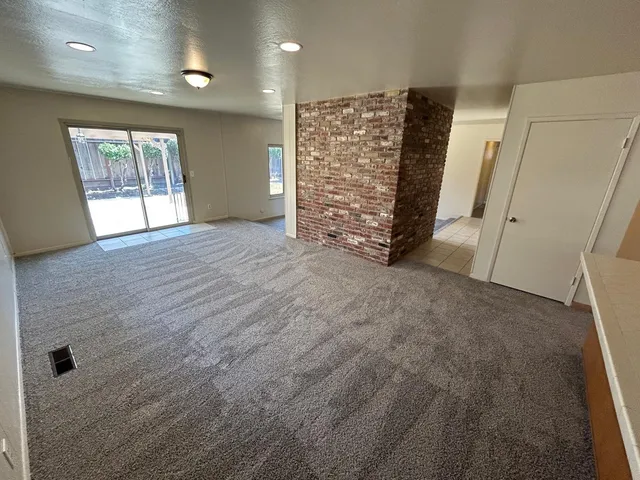 view of an empty room with a fireplace