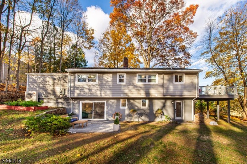 a view of a house with backyard porch and sitting area