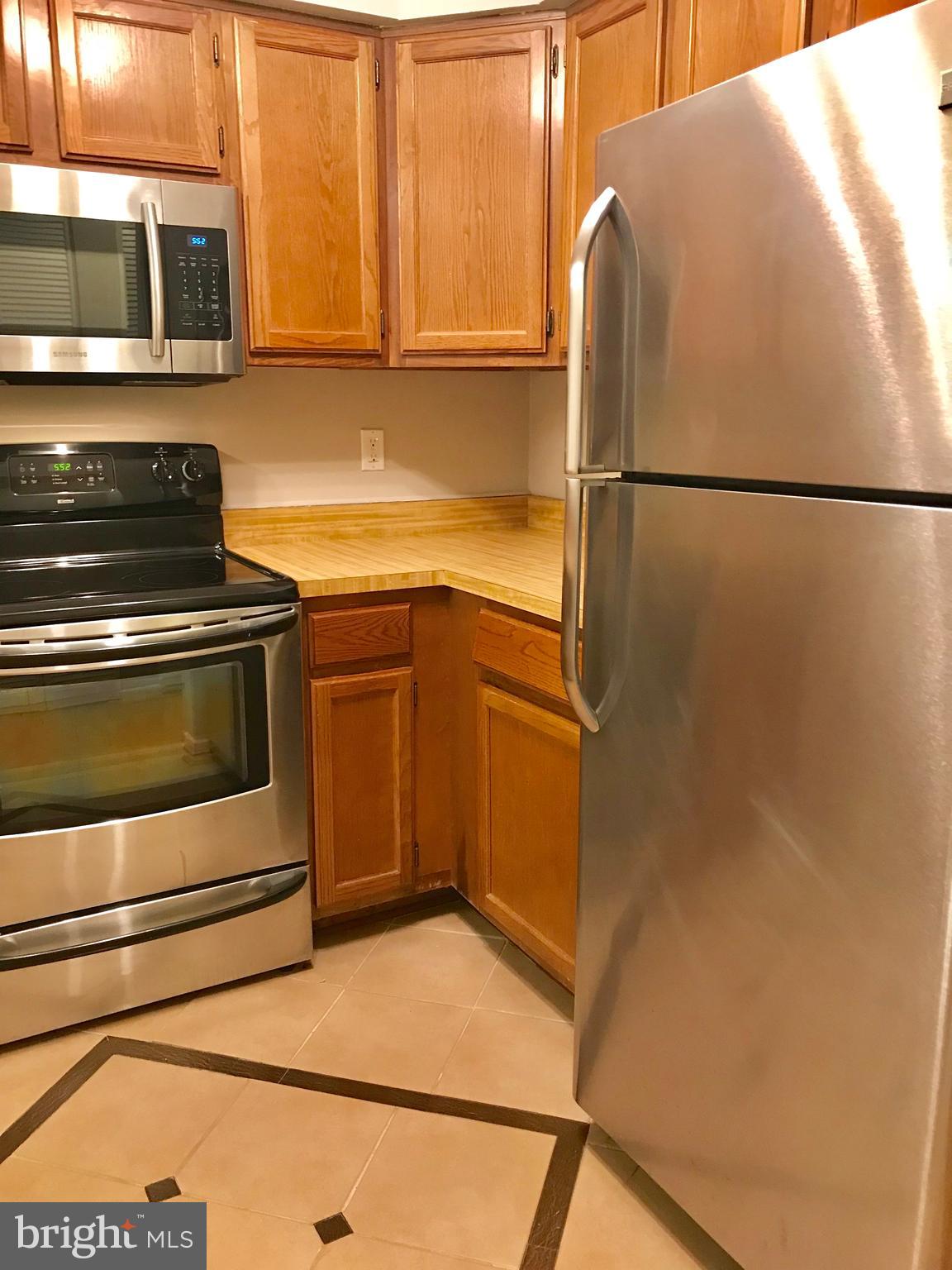 7702 Lexton Place, Unit 65 Springfield, VA 22152 - Photo 10 of 24 a kitchen with a refrigerator and a stove
