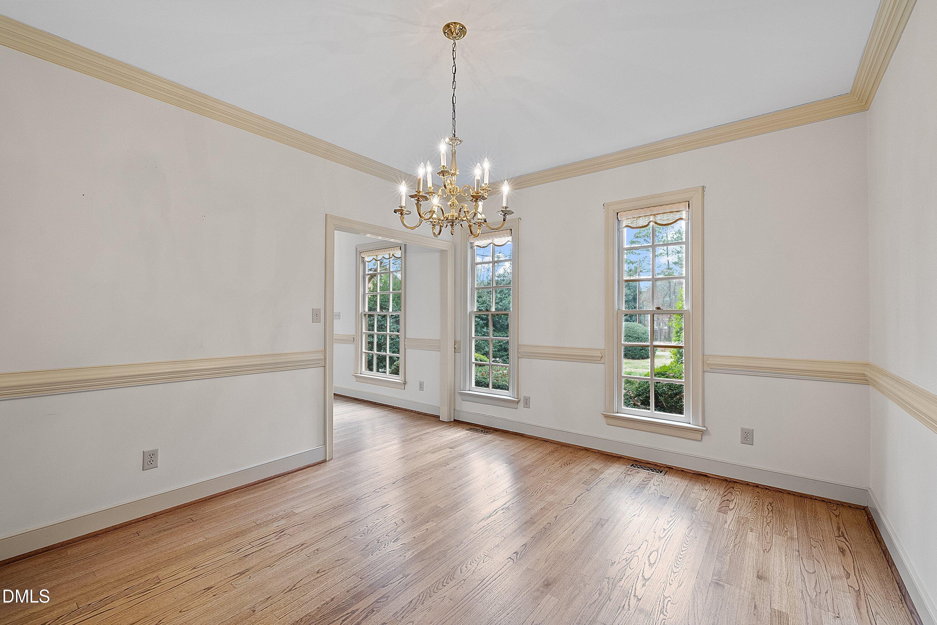 1708 Sawgrass Court Raleigh, NC 27615 - Photo 10 of 60 a view of an empty room with wooden floor and a window