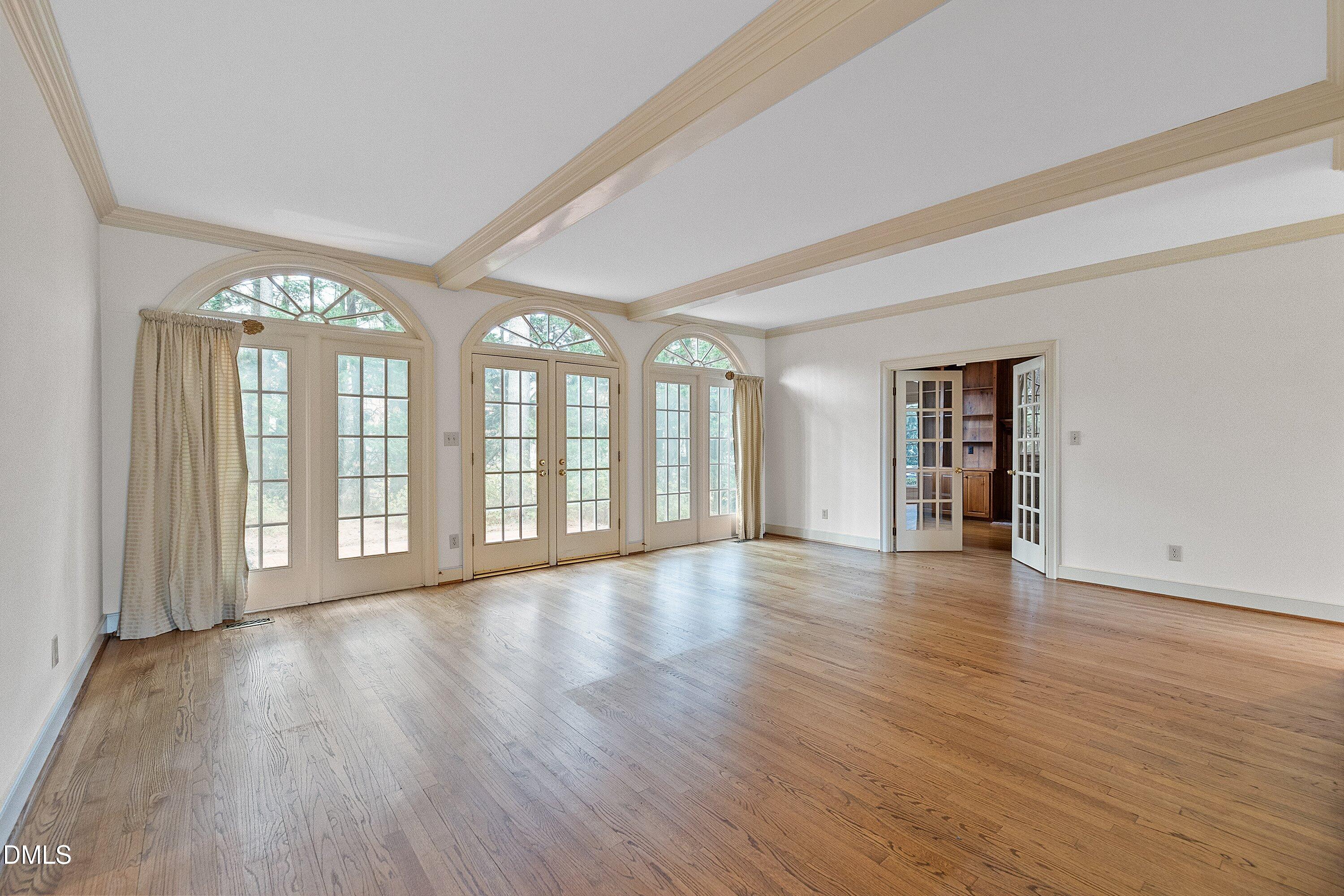 1708 Sawgrass Court Raleigh, NC 27615 - Photo 12 of 60 a view of an empty room with wooden floor and a window
