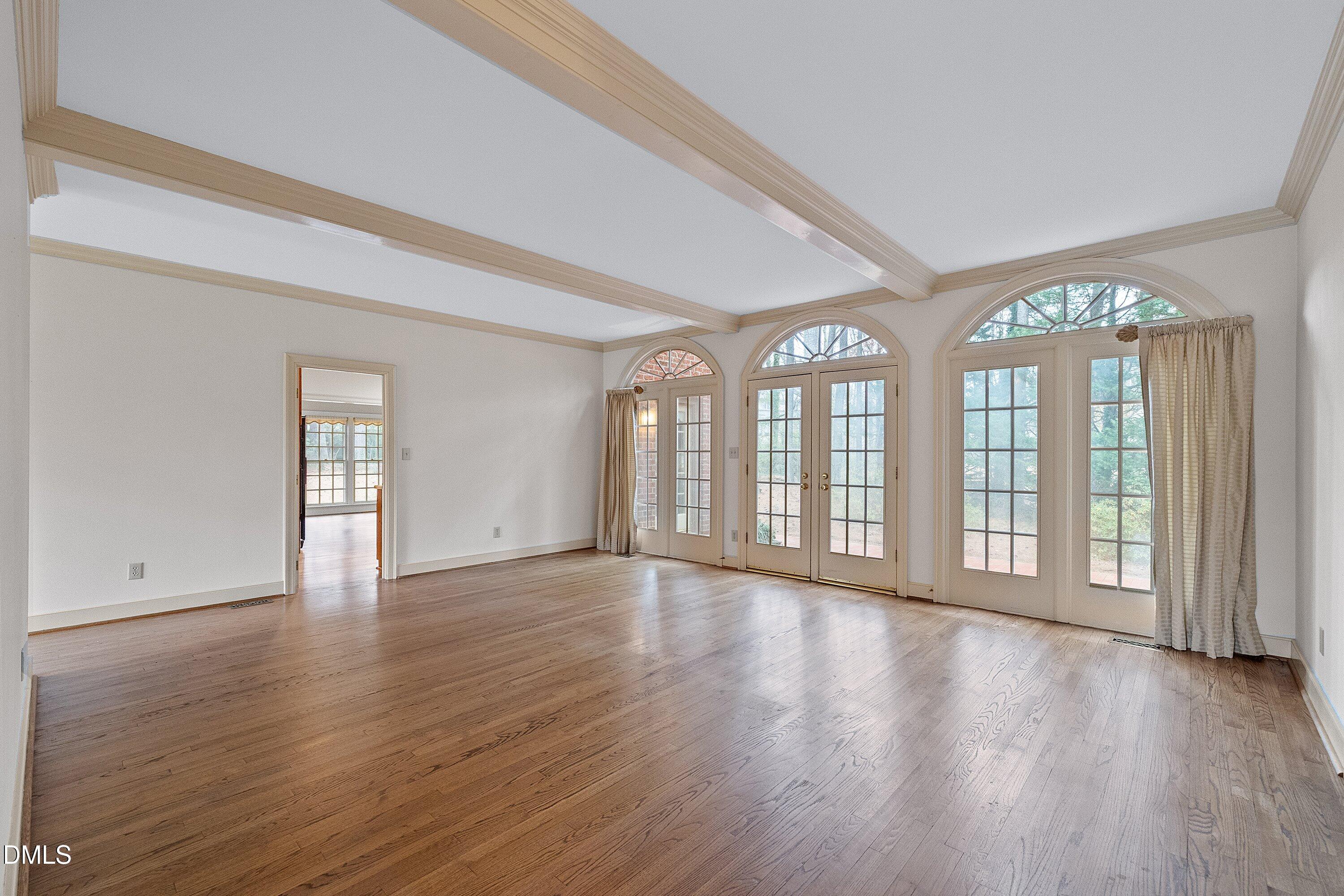 1708 Sawgrass Court Raleigh, NC 27615 - Photo 13 of 60 a view of an empty room with wooden floor and a window