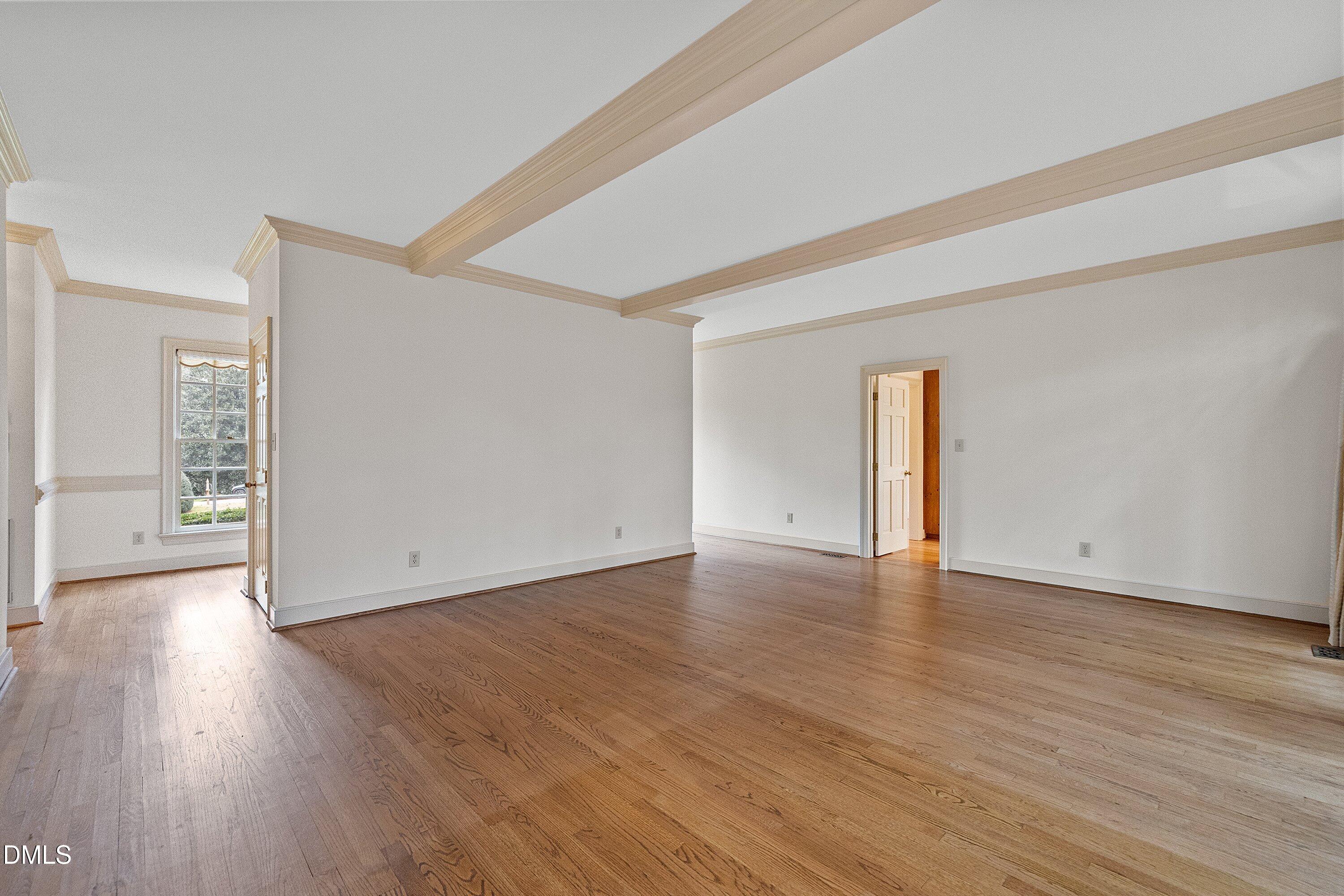 1708 Sawgrass Court Raleigh, NC 27615 - Photo 14 of 60 a view of an empty room with wooden floor