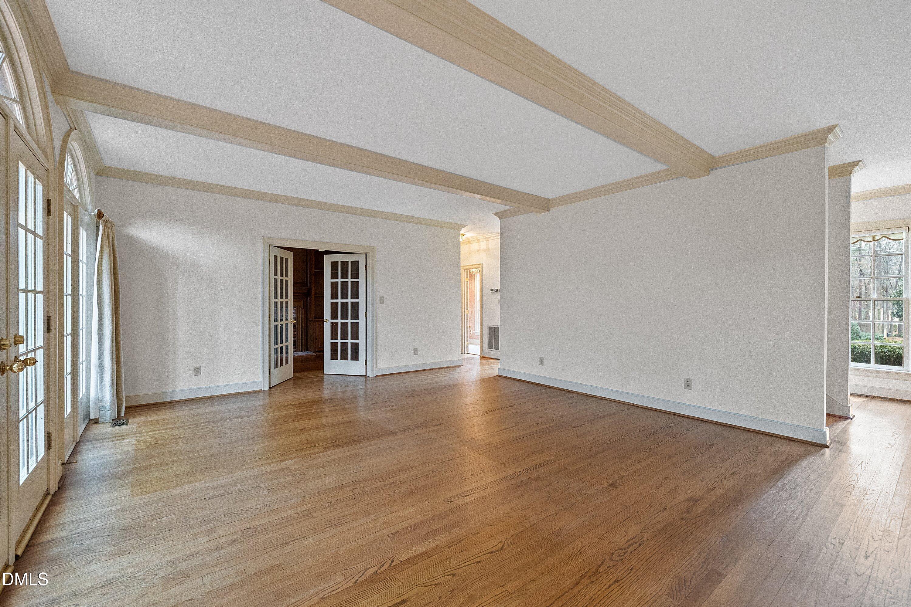 1708 Sawgrass Court Raleigh, NC 27615 - Photo 15 of 60 a view of an empty room with wooden floor and a window
