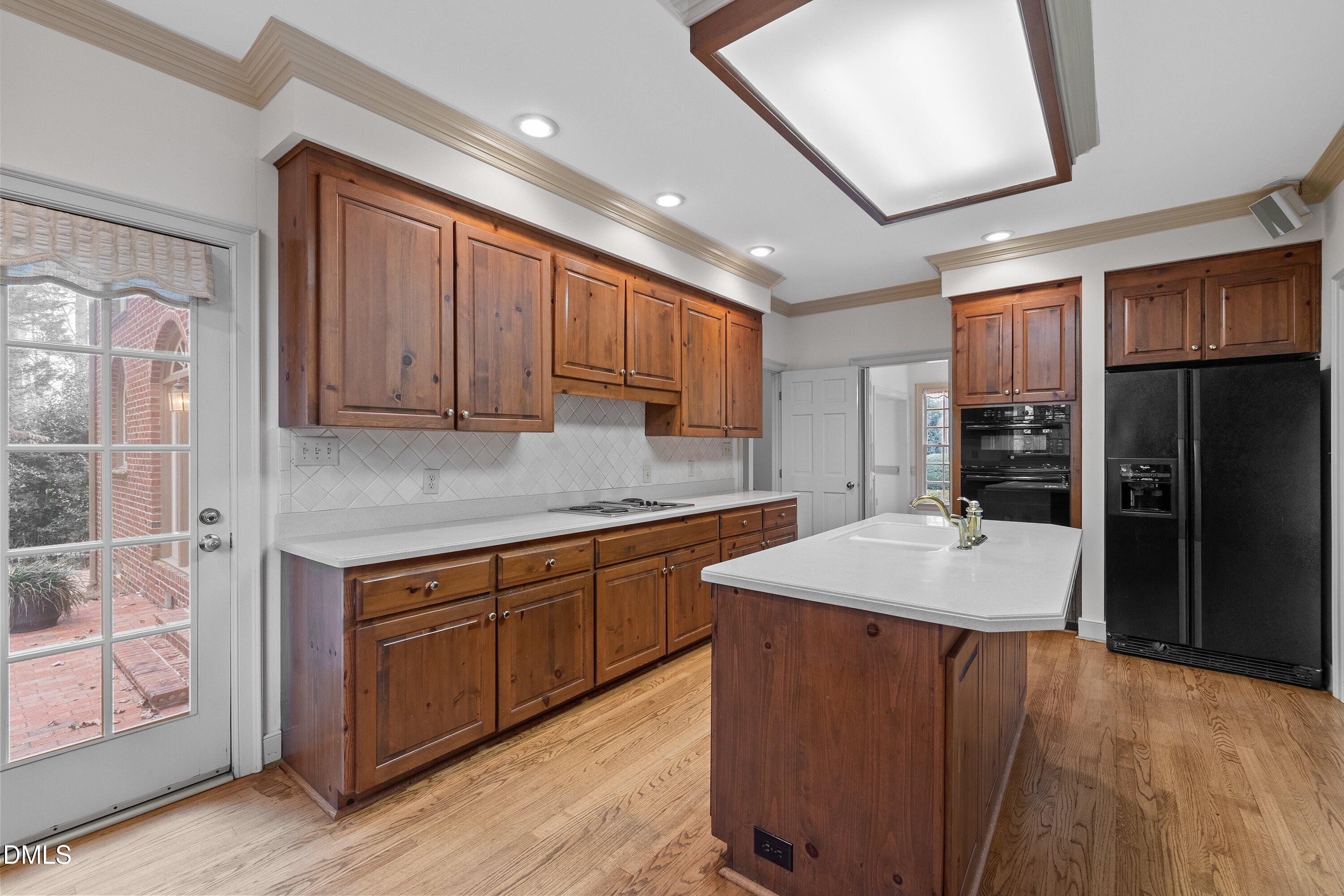 1708 Sawgrass Court Raleigh, NC 27615 - Photo 22 of 60 a kitchen with stainless steel appliances granite countertop a refrigerator a sink dishwasher a stove and white cabinets with wooden floor