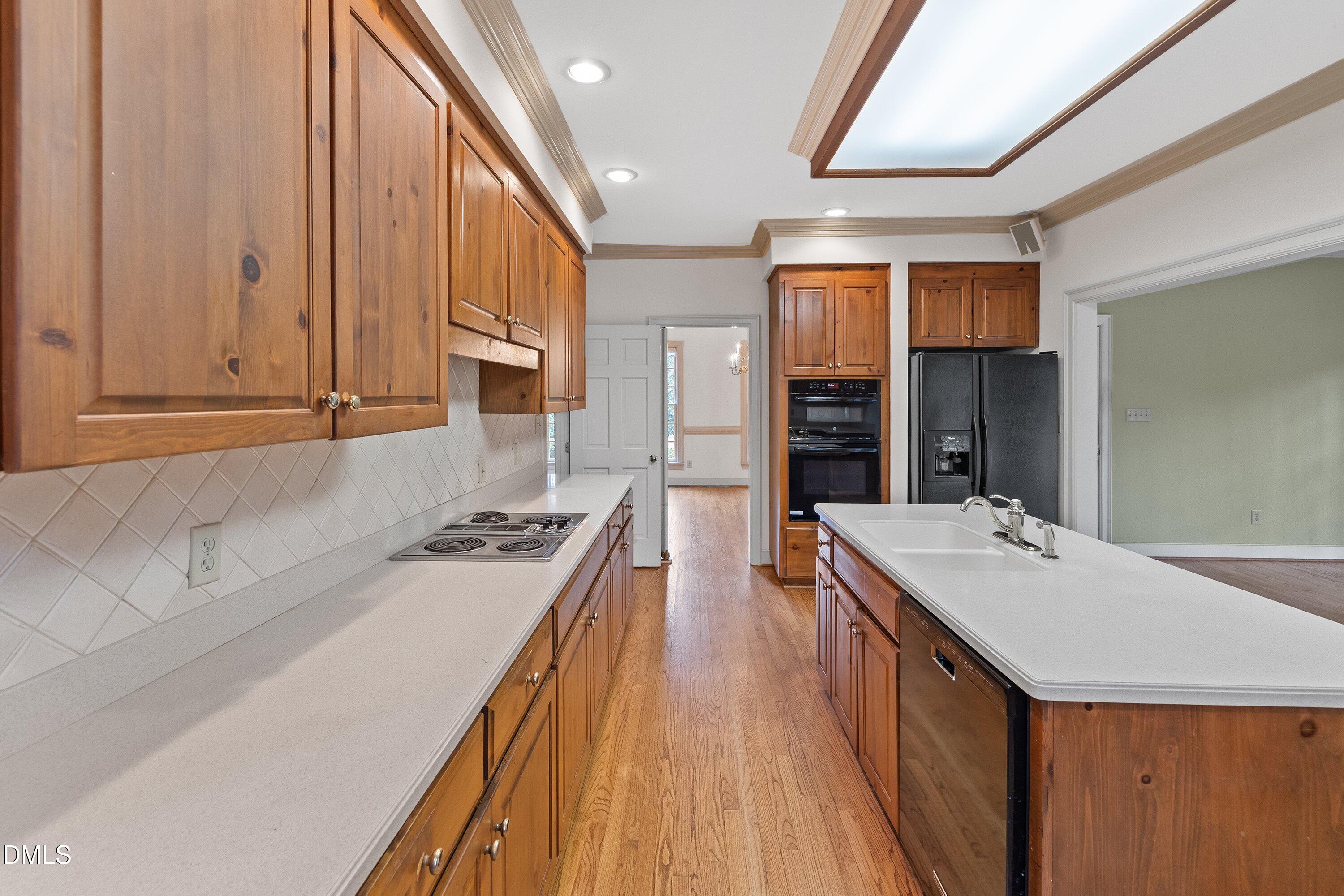 1708 Sawgrass Court Raleigh, NC 27615 - Photo 24 of 60 a kitchen with a stove a sink and a refrigerator