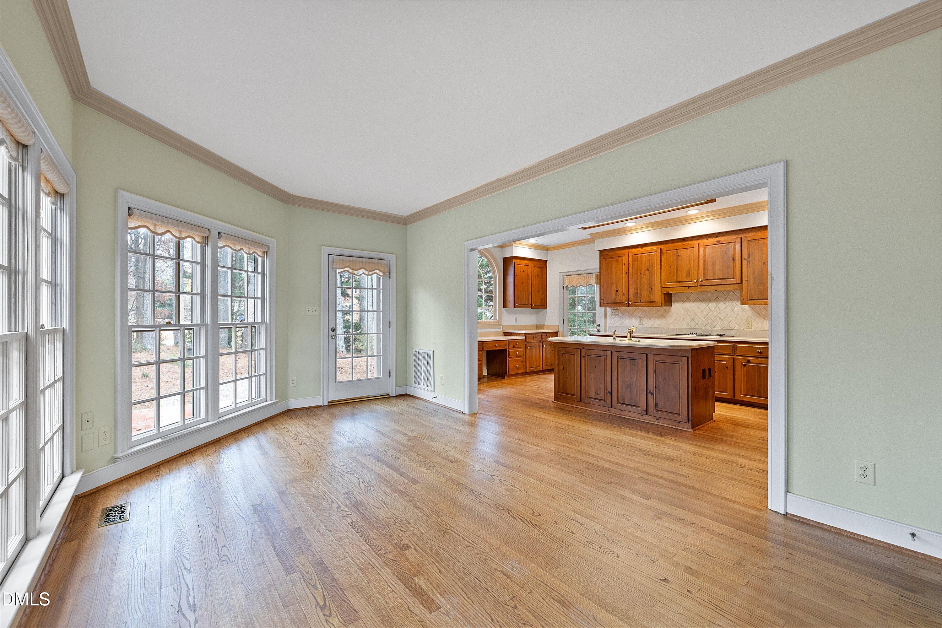 1708 Sawgrass Court Raleigh, NC 27615 - Photo 28 of 60 a view of a kitchen with stainless steel appliances granite countertop a stove top oven a sink dishwasher and white cabinets with wooden floor
