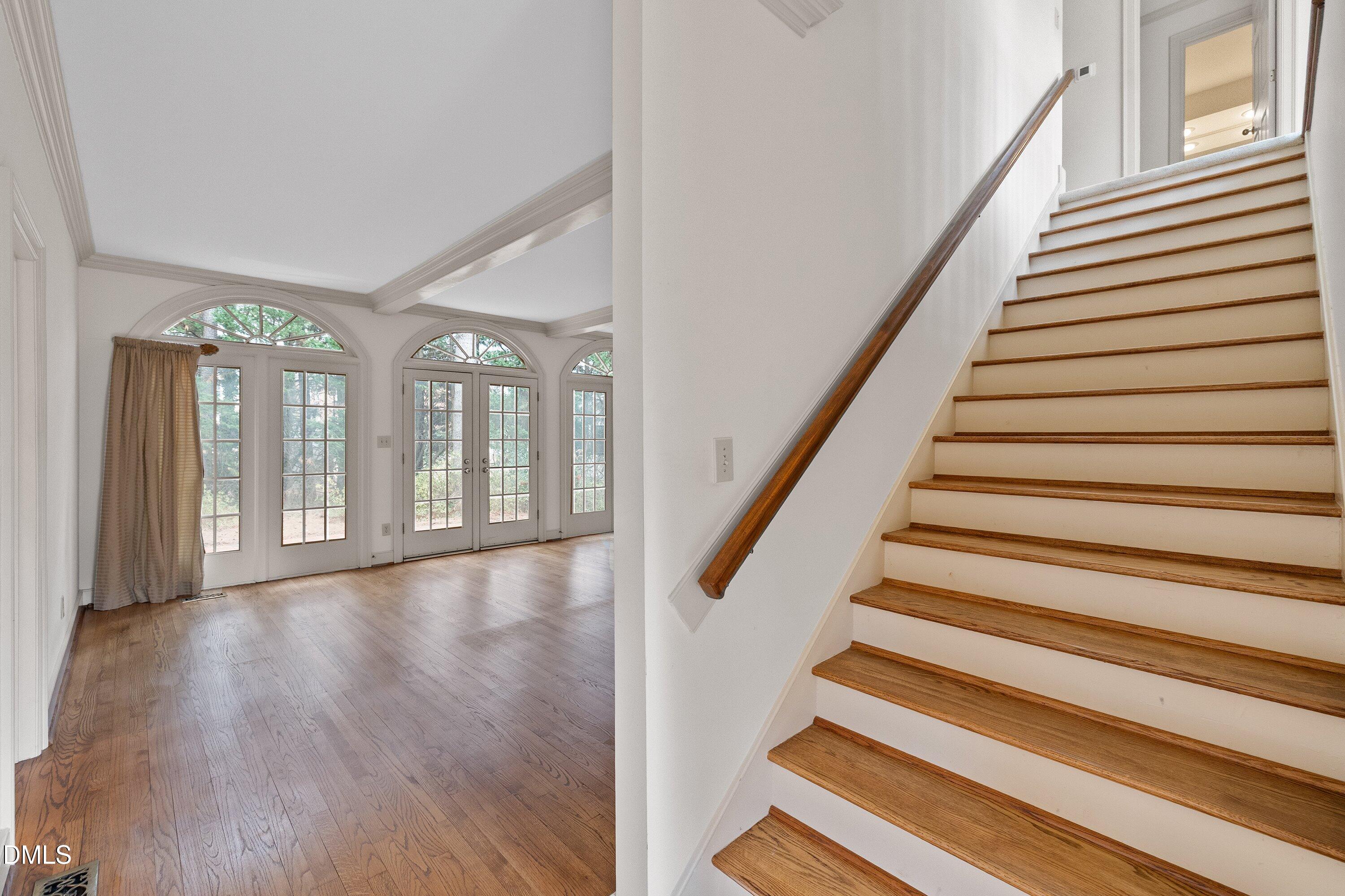 1708 Sawgrass Court Raleigh, NC 27615 - Photo 30 of 60 a view of an entryway with wooden floor and stairs