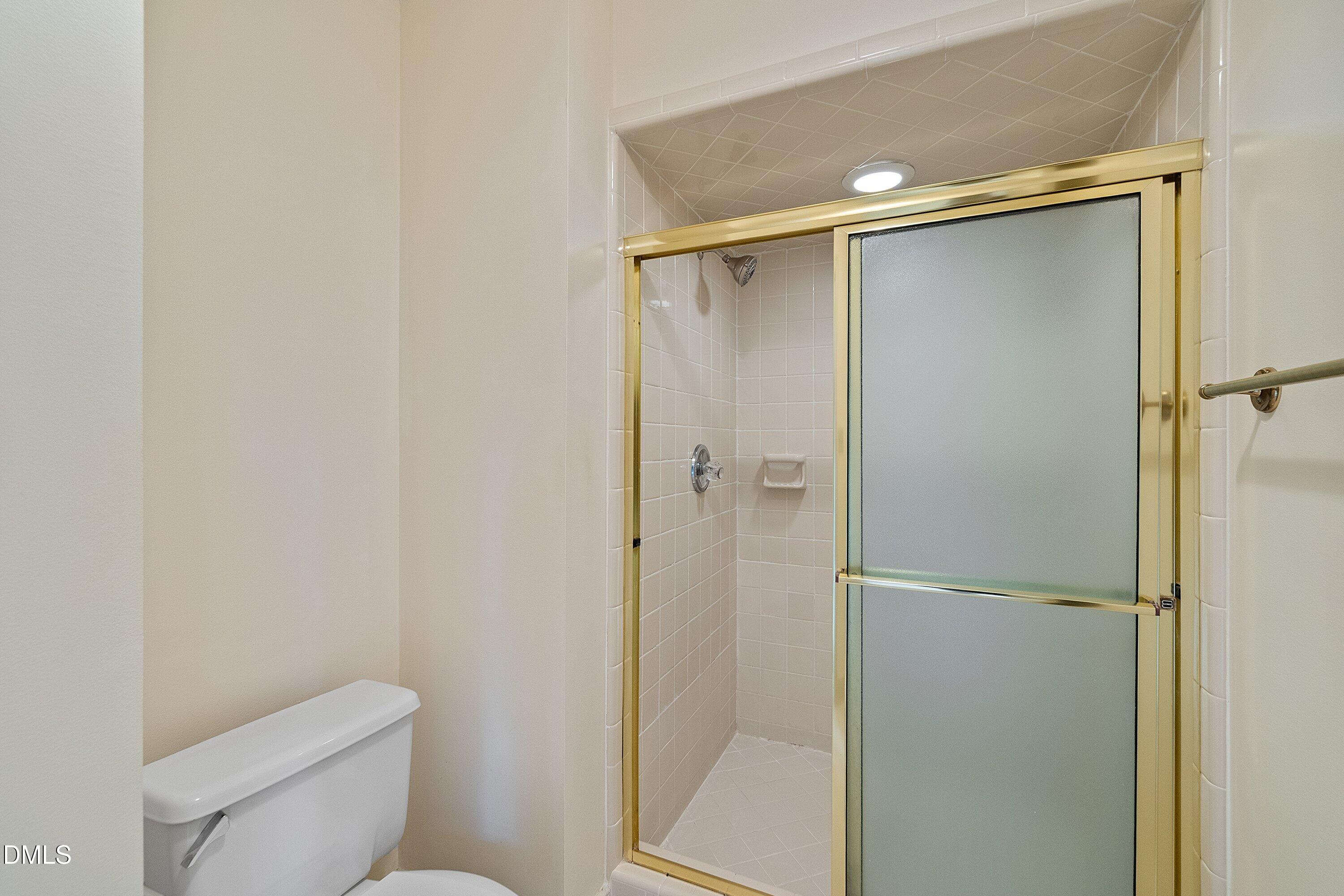 1708 Sawgrass Court Raleigh, NC 27615 - Photo 39 of 60 a bathroom that has a glass shower door