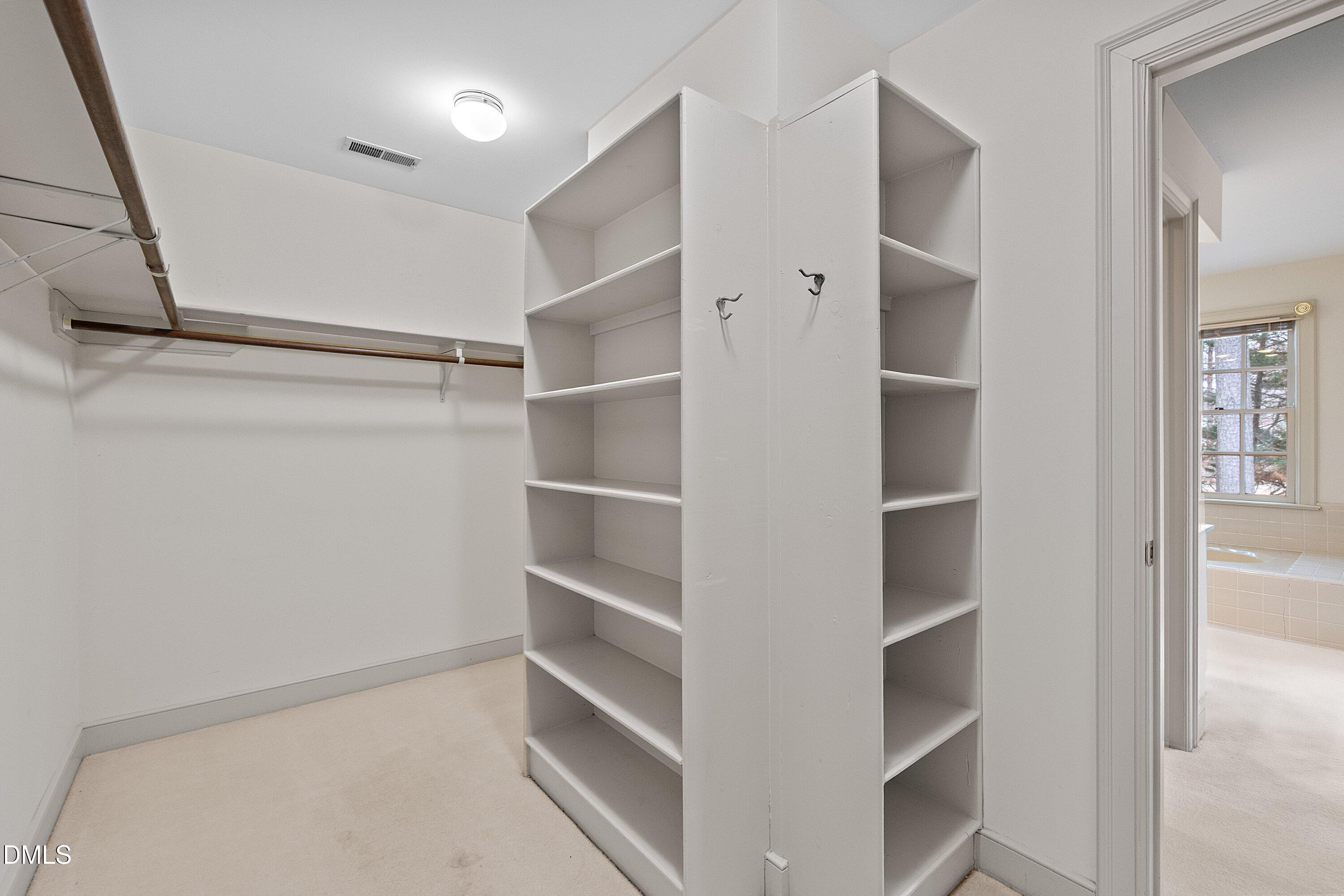 1708 Sawgrass Court Raleigh, NC 27615 - Photo 40 of 60 a view of walk in closet with empty racks