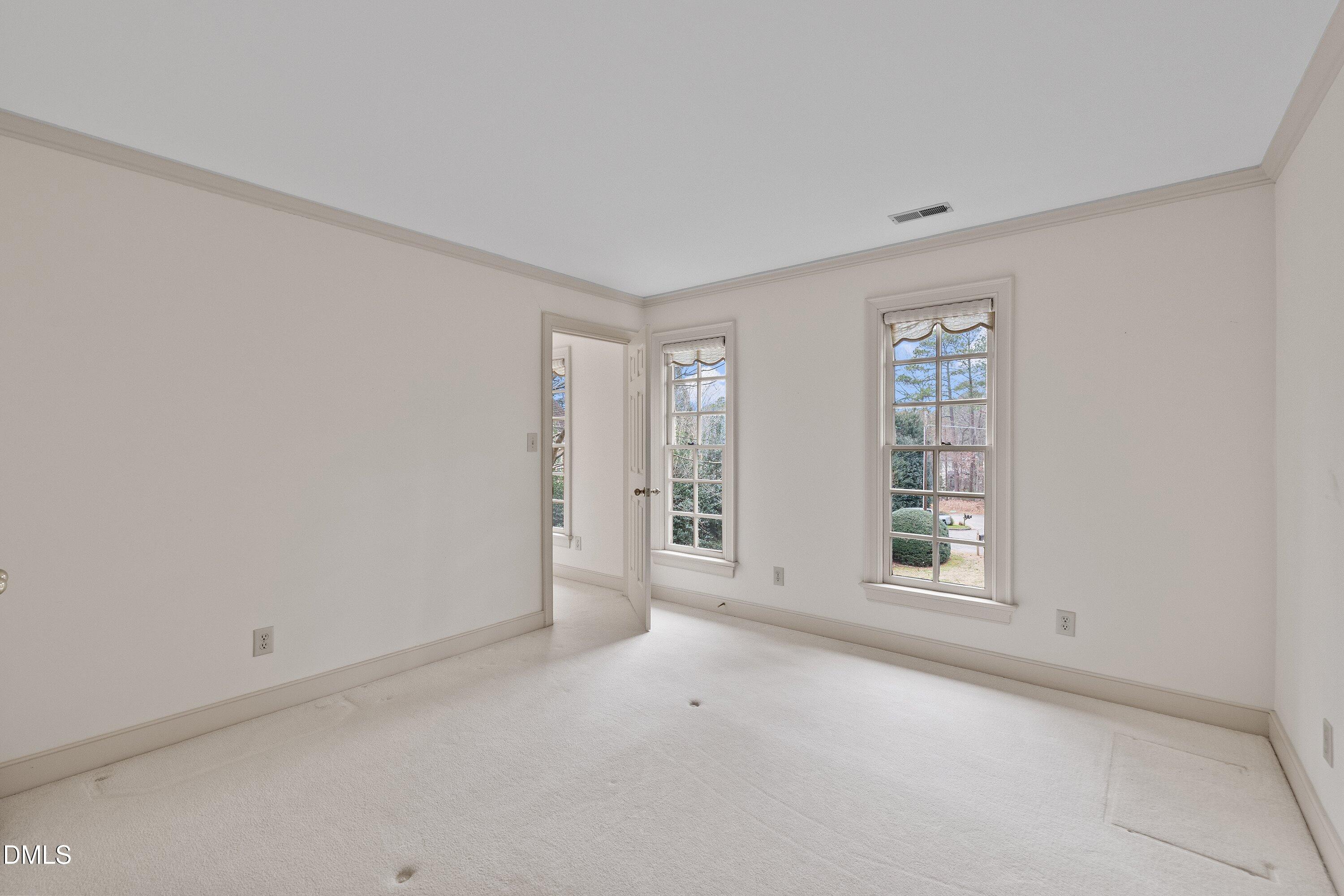 1708 Sawgrass Court Raleigh, NC 27615 - Photo 42 of 60 an empty room with windows