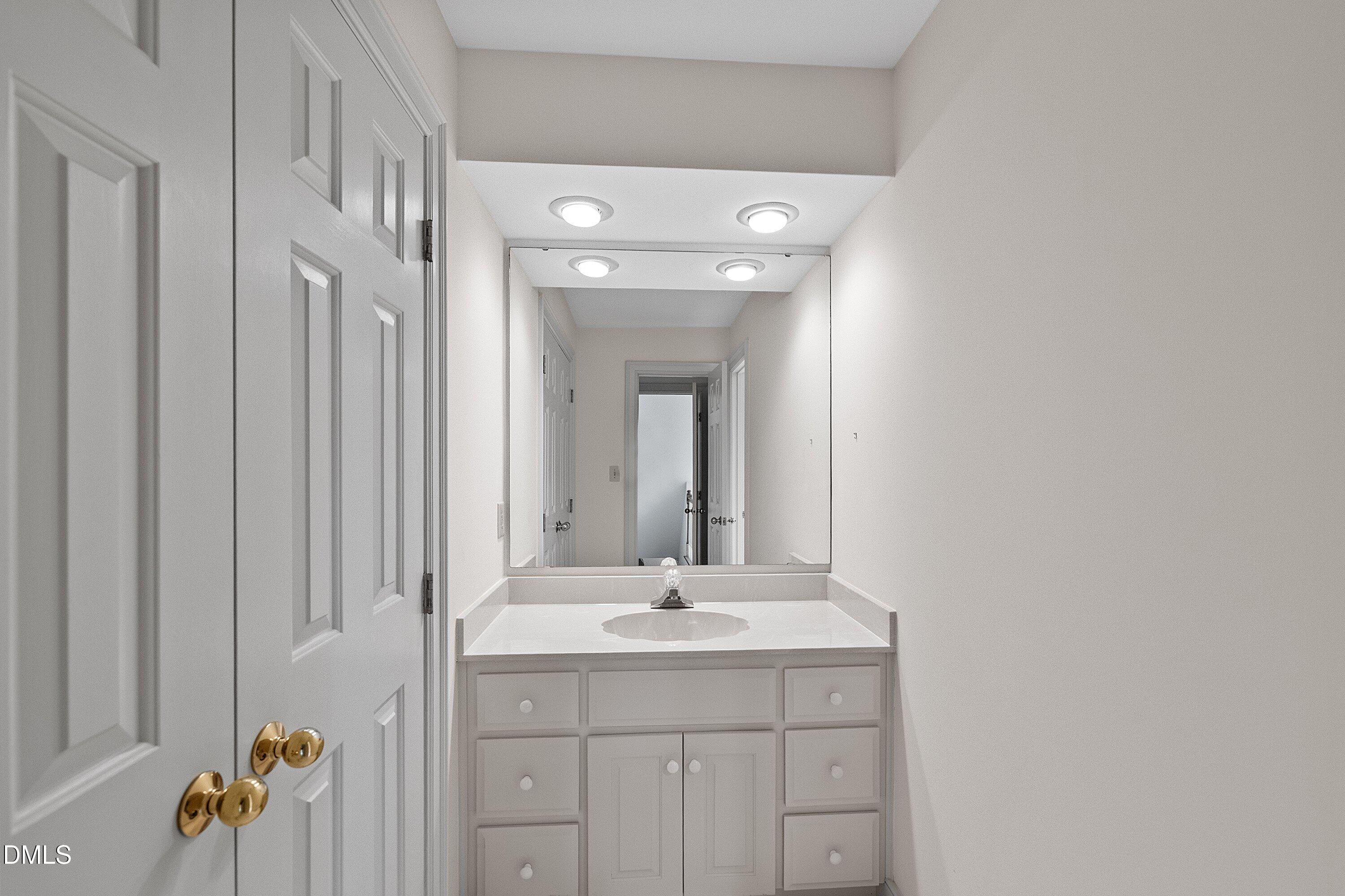 1708 Sawgrass Court Raleigh, NC 27615 - Photo 46 of 60 a bathroom with a sink vanity and a mirror